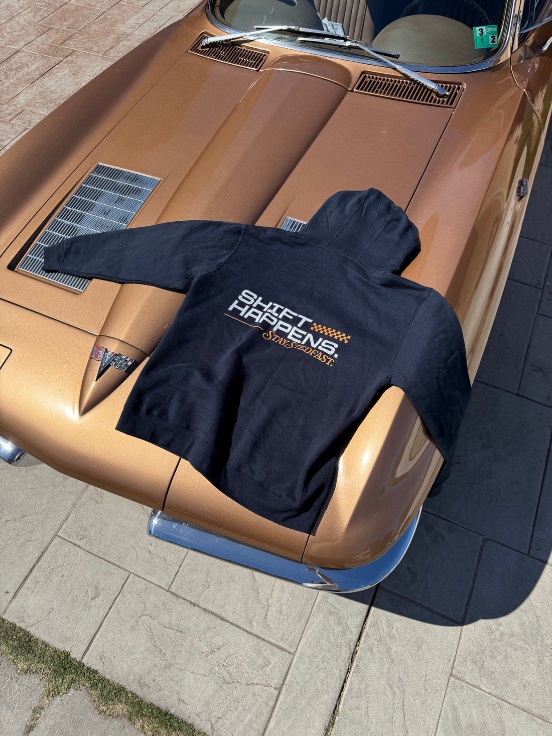 Cool car guy hoodie on hood of classic corvette. Shift Happens, Stay Stedfast logo on Navy Hoodie